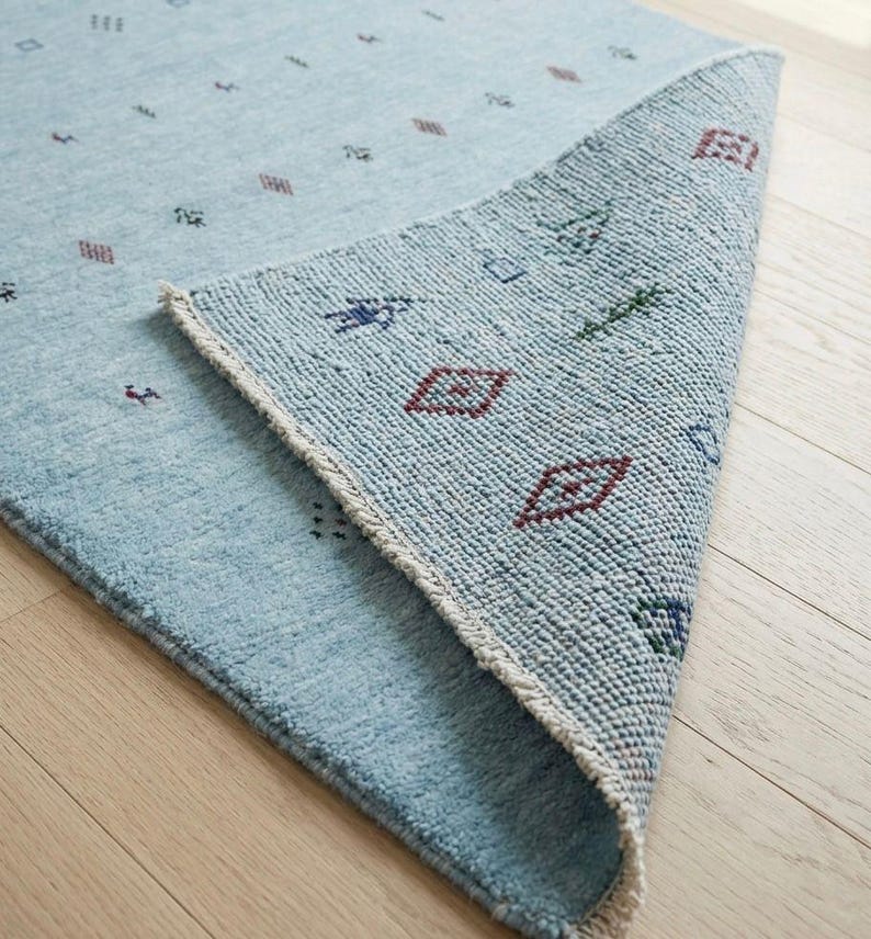 Artisanal Hand-Knotted Pale Azure Rug with Folk Symbols